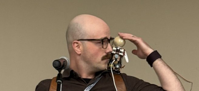 Photo of Dylan and ORBiE onstage, about to perform "Ineffable Idiosyncrasy".